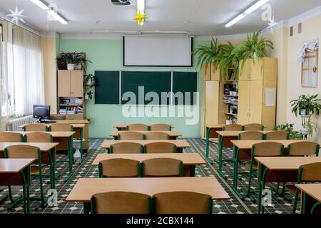 selective soft and blur focus.old wooden row lecture chairs in classroom in poor school.study room without student.concept for education Stock Photo