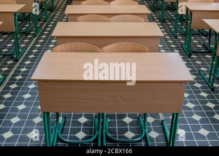 selective soft and blur focus.old wooden row lecture chairs in classroom in poor school.study room without student.concept for education Stock Photo