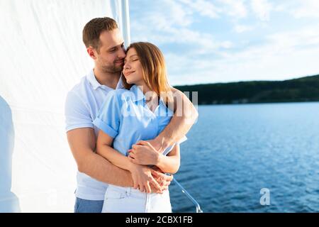 Loving Couple Hugging Enjoying Romantic Yacht Tour On Vacation Stock Photo