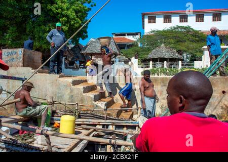 Unloading construction materials from a ship in the Lamu port, Kenya, Lamu island UNESCO World Heritage site Stock Photo