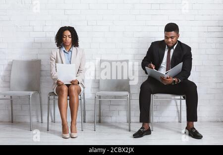 African American vacancy applicants waiting for job interview in company office Stock Photo