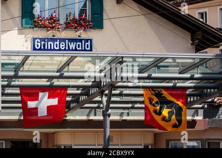 Grindelwald, Bernese Oberland, Switzerland - August 1 2019 : the flags of Switzerland and the canton Bern waving in the Grindelwald railway station on Stock Photo