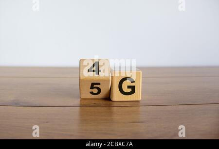 Change wooden block from 4G to 5G. Technology, network, communication concept. Beautiful wooden table. White background, copy space. Stock Photo