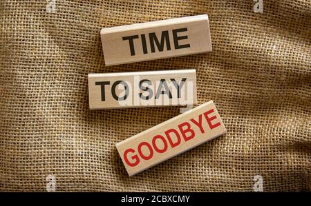 Concept text 'time to say goodbye' on wooden blocks on a beautiful canvas background. Business concept. Stock Photo