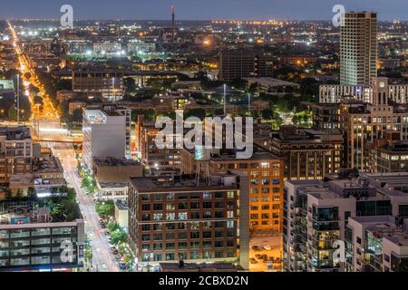 Aerial view of the urban landscape at dusk, featuring dense buildings ...