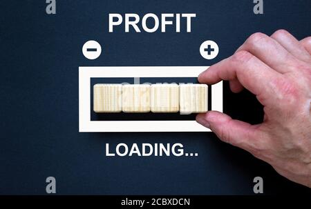 Transformation business and growth concept with progress bar. Male hand. Beautiful black background. Words 'profit, loading'. Stock Photo