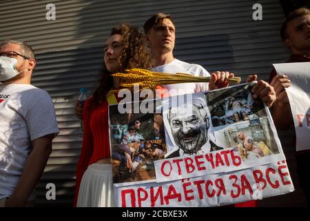 Moscow, Russia. 16th of August, 2020 People hold a banner during a protest rally against the official results of the Belarusian presidential election in front of Belarusian Embassy in Moscow, Russia. A banner reads 'Need to answer for everything' Stock Photo