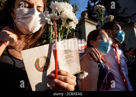 Moscow, Russia. 16th of August, 2020 A woman holds Belarusian passport during a protest rally against the official results of the Belarusian presidential election in front of Belarusian Embassy in Moscow, Russia Stock Photo
