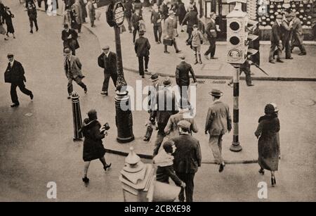 Following increased road accidents in 1934, pedestrian traffic lights, nail studded corridors across busy roads at a London cross roads. Stock Photo