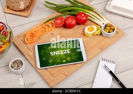 Healthy Tablet Pc compostion with SNEEZE inscription, immune system boost concept Stock Photo