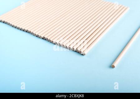 Paper drinking straws on light blue background. Stock Photo
