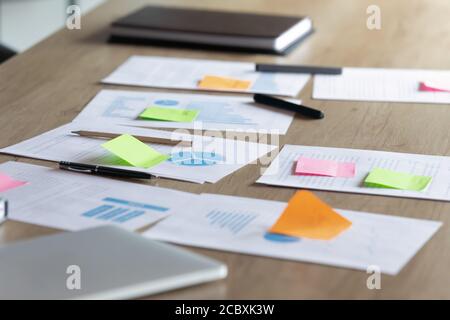 Close up paper marketing research reports on table.