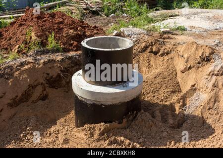 Sewerage during construction. Installed concrete rings for the sewer system. The channel Stock Photo