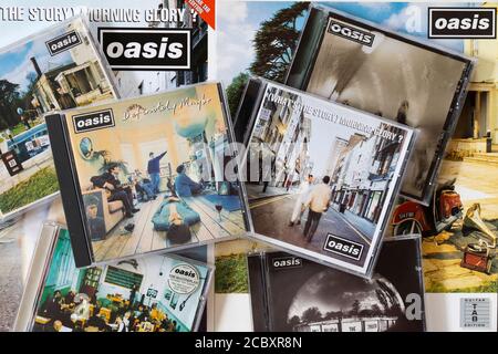 A selection of Oasis CD albums with covers including their debut album Definitely Maybe and second album What's the Story Morning Glory - Britpop Stock Photo