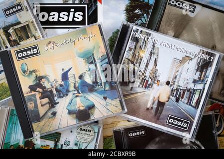 A selection of Oasis CD albums with covers including their debut album Definitely Maybe and second album What's the Story Morning Glory - Britpop Stock Photo