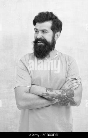 Grow long beard. Challenges like dryness ingrown hairs and irritation. Find best beard design shape for facial hair. Products is essential for maintaining men beard care. Bearded hipster brutal guy. Stock Photo