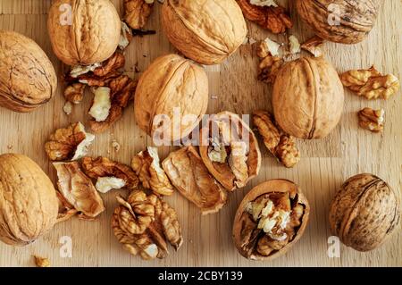 ripe walnuts, in shell and cracked, fruit, seeds, isolated, wrinkled, macro, shell Stock Photo