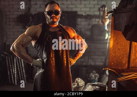 Attractive, muscular construction worker wearing open denim jacket ...