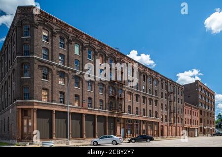 19th Century warehouse industrial buildings along railroad tracks in downtown Burlington Stock Photo