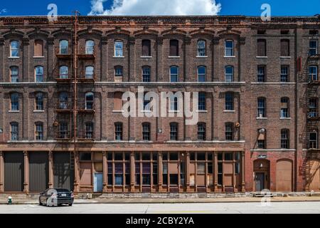 19th Century warehouse industrial buildings along railroad tracks in downtown Burlington Stock Photo