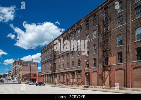 19th Century warehouse industrial buildings along railroad tracks in downtown Burlington Stock Photo