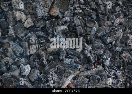 Black charcoal texture background. Close-up shot. Top view. Close-up charcoal texture. Stock Photo