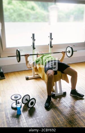 Bearded guy lifting weights at the gym Stock Photo