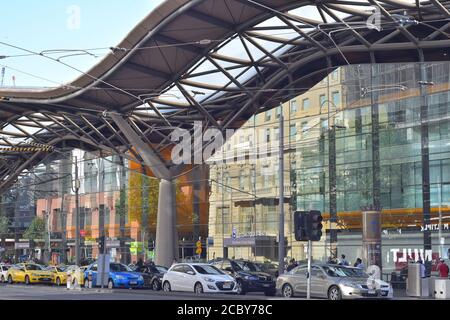 Glass facade of Southern Cross railway station reflecting images of city buildings on opposite side of street. Stock Photo