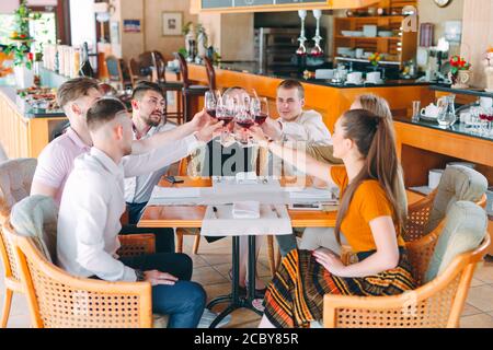Friends drink wine on the terrace of the restaurant. Stock Photo