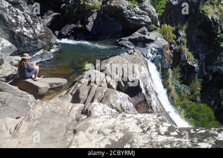 Sitting at the pool at the top of Windin Falls, Wooroonooran national Park, queensland, Australia. No MR Stock Photo