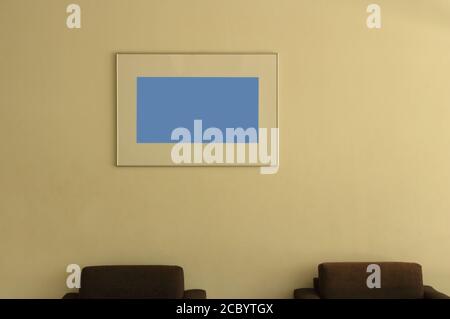Closeup empty photo frame hanging on the wall of living room under sunlight Stock Photo