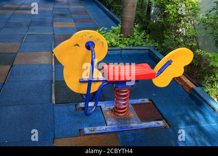 Closeup empty spring rider installed in playground Stock Photo