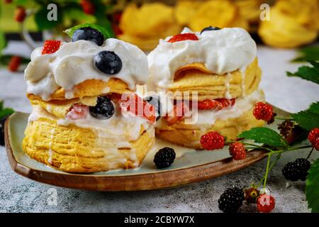 Southern british sweet dessert flaky biscuits with whipped cream and berries. Close up. Stock Photo