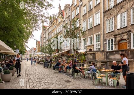 Unidentified people seats in outdoor cafe in central part of Gdansk, Poland. Stock Photo