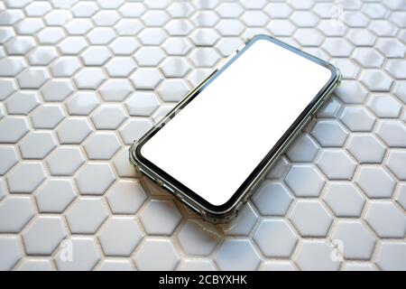 Mobile phone blank screen to fill graphics Placed on the area with a hexagonal honeycomb mosaic pattern. Stock Photo