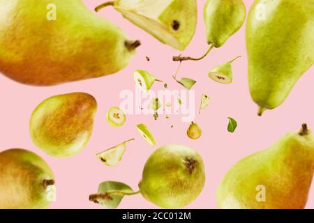 Fresh pears falling from top to bottom on a pink background. Fruit abundance concept. Pattern Stock Photo