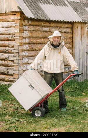 Aromashevsky Russia MaY 24 2018 The beekeeper carries on the cart a new home for bees Stock Photo