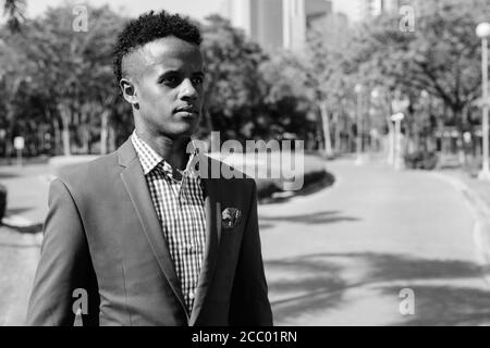 Young handsome African businessman relaxing at the park Stock Photo