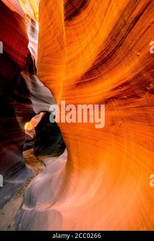 Mysterious Lower Antelope Canyon in Page Arizona with natural landscapes of bright sandstones stacked in flaky fire waves in a narrow sandy labyrinth Stock Photo