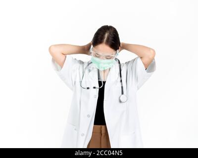 Asian woman doctor wearing medical face mask, face shield and white coat is collecting hair isolated on white background. Portrait of young attractive Stock Photo
