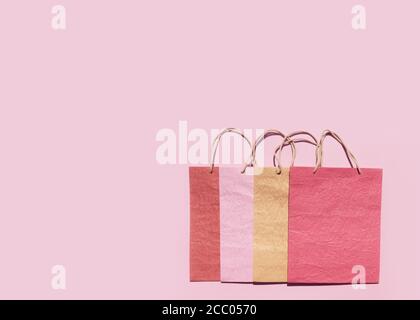 Colourful textured paper shopping bags on pink background. Minimal fashion shopping online concept. Copy space top view flat lay Stock Photo Alamy