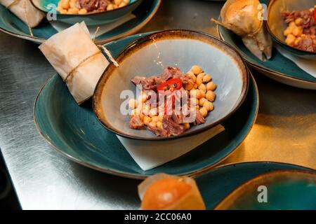 The process of attracting soup from chickpea and meat. The plate contains all the ingredients except the broth. Stock Photo