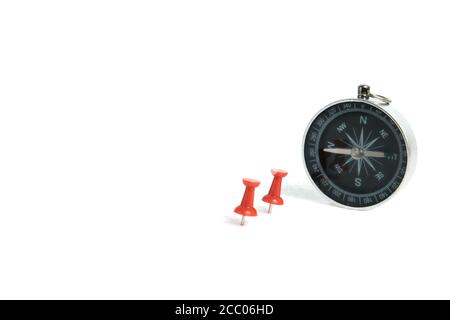 Two embedded red thumbtack / pushpin with compass isolated on white background Stock Photo