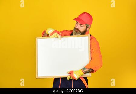 professional skills. architect and engineering drawing. contractor giving presentation. Presentation on flipchart plan for construction. Builder men points on flipchart. Engineer project, copy space. Stock Photo