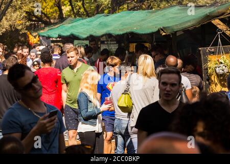 Johannesburg, South Africa - May 24, 2015: Crowds of diverse people at outdoor farmer's market walking through the take out food section Stock Photo