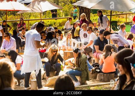 Johannesburg, South Africa - May 24, 2015: Crowds of diverse people sitting in the beer garden at outdoor farmer's market Stock Photo