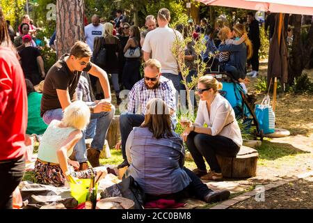 Johannesburg, South Africa - May 24, 2015: Crowds of diverse people sitting in the beer garden at outdoor farmer's market Stock Photo