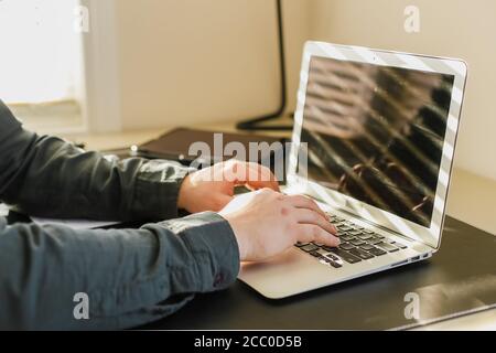 Close up male hands typing on laptp keyboard. Stock Photo