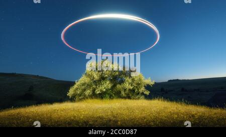 Tree and flying drone is painting light at starry night Stock Photo