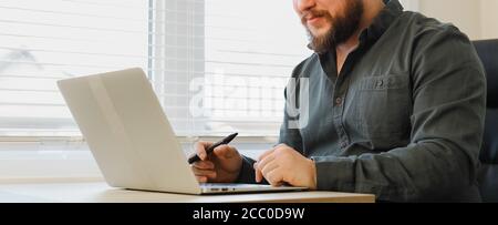 Close up portrait of business man using laptop at office. Stock Photo